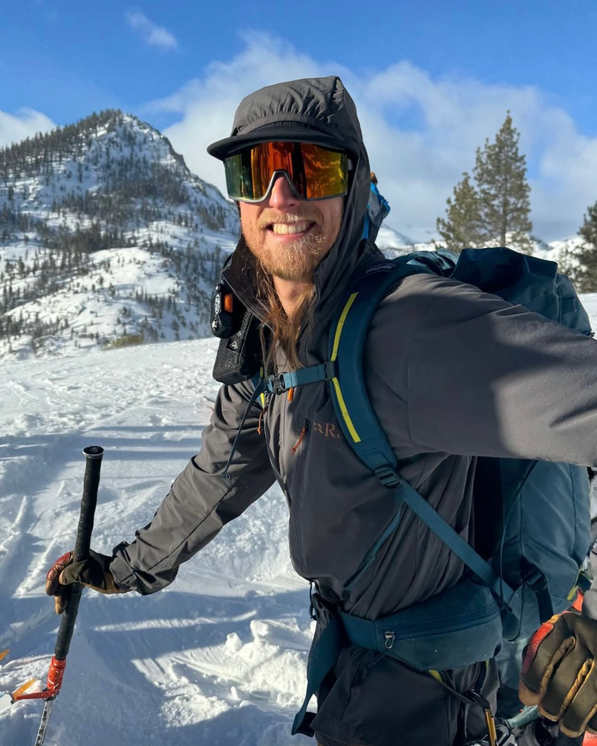 A skier wears a softshell jacket while backcountry skiing