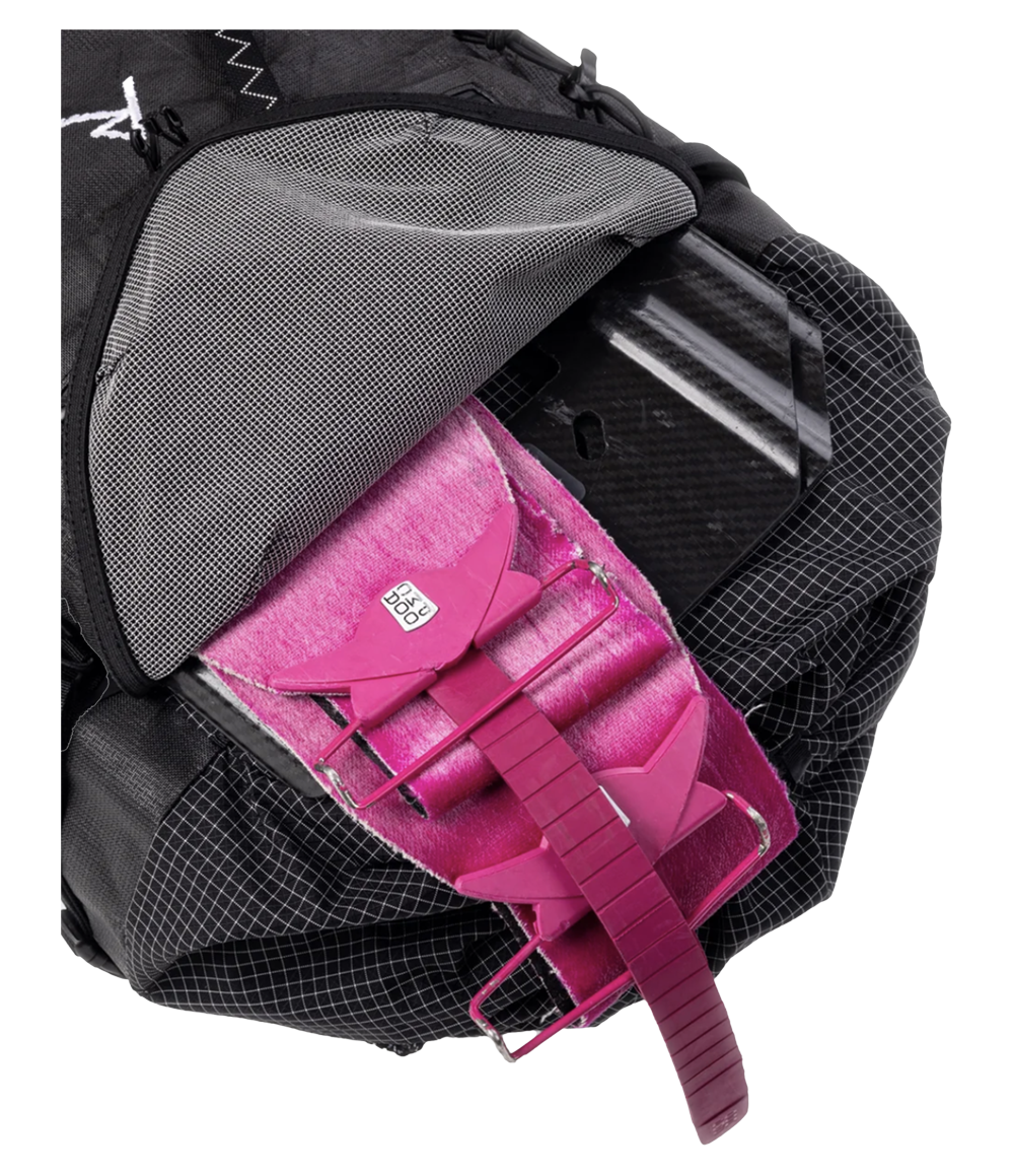Raide SB 40L Black backcountry ski pack shown with back panel access open, revealing breathable mesh back panel, pink avalanche shovel with elastic retention straps, and structured internal organization with ripstop fabric lining
